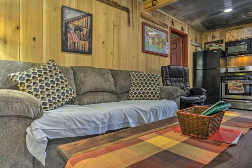 a living room with a couch and a refrigerator at Kentucky Cabin with 2 Fishing Ponds and Trail Access in New Concord