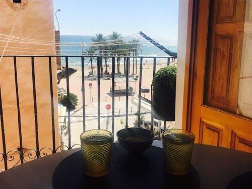 a balcony with a view of a beach and the ocean at Segunda casa de Ana Lucia en la playa in Villajoyosa