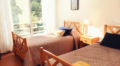 a bedroom with two beds and a window at Iason Seaview home in Latchi in Polis Chrysochous
