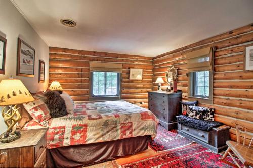 a bedroom with a bed in a room with wooden walls at Award-Winning Log Cabin, Top 5 in New England! in Londonderry