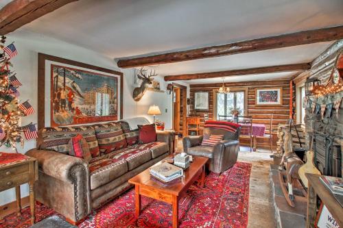 a living room with a couch and a christmas tree at Award-Winning Log Cabin, Top 5 in New England! in Londonderry