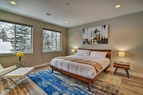 a bedroom with a large bed and two windows at Modern Anchorage Townhome - By Delaney Park Strip! in Anchorage