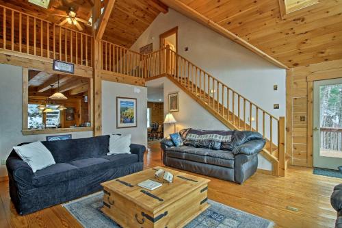 a living room with a couch and a table at Spacious Gilford Retreat with Deck 2 Mi to Skiing! in Gilford