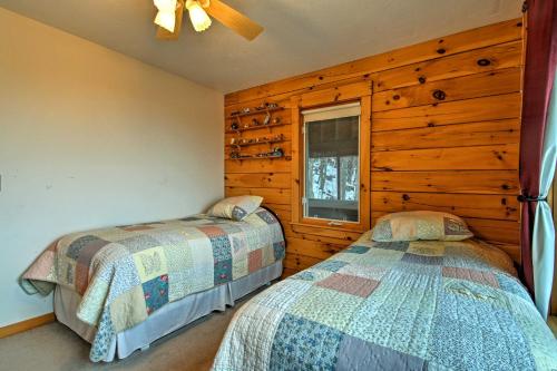 a bedroom with two beds and a window at Spacious Gilford Retreat with Deck 2 Mi to Skiing! in Gilford