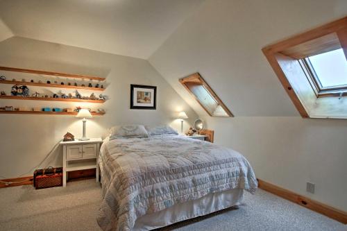 a bedroom with a bed and a desk and a window at Spacious Gilford Retreat with Deck 2 Mi to Skiing! in Gilford
