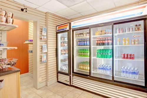 a refrigerator filled with lots of water and soda at Ramada by Wyndham West Memphis in West Memphis