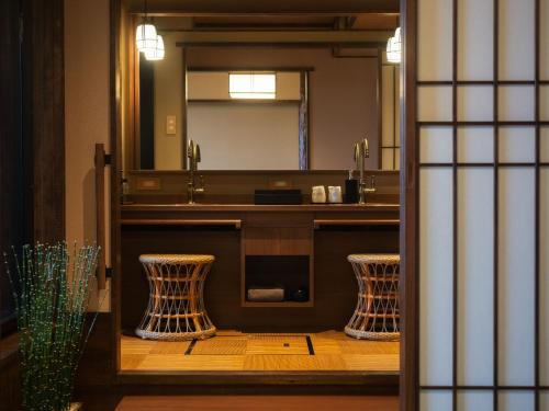 a bathroom with a sink and a mirror at Koran no Yu Kinkouro in Ibusuki