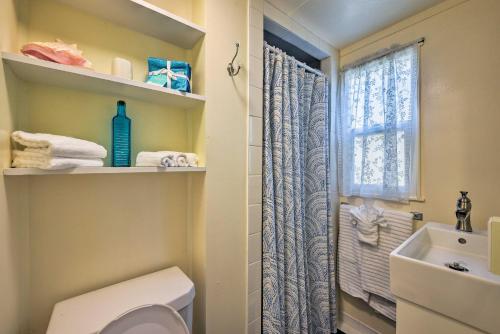 a bathroom with a toilet and a sink and a window at Catalina Island Cottage - Walk to Main St and Beach! in Avalon