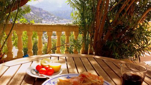 a table with a plate of food and a glass of soda at Casa Sol with private terrace, garden, pool, beautiful view in Port de Soller