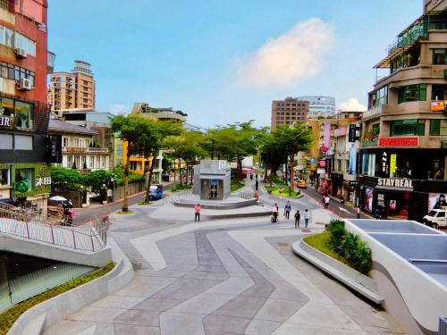 a street in a city with people walking around at K Hotel Taipei in Taipei