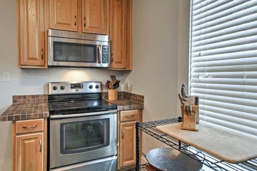 a kitchen with a stove and a microwave at Historic Moss Point House with Loft - 6 Mi to Beach! in Moss Point