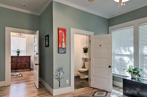 a bathroom with green walls and a toilet at Historic Moss Point House with Loft - 6 Mi to Beach! in Moss Point