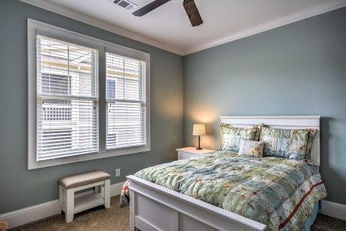 a bedroom with a bed and two windows at Near Sugar Creek Spacious Family-Friendly Retreat in Greensboro