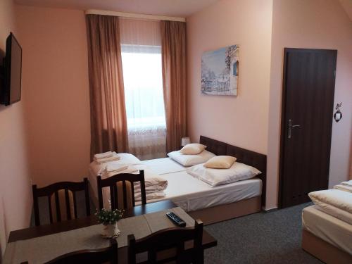 Postel nebo postele na pokoji v ubytování Sum Restauracja & Hotel