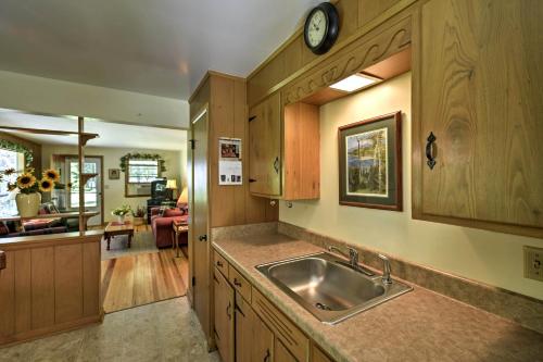 a kitchen with a sink and a living room at Ephraim Vacation Rental - 3 Mi to Fish Creek Beach in Ephraim