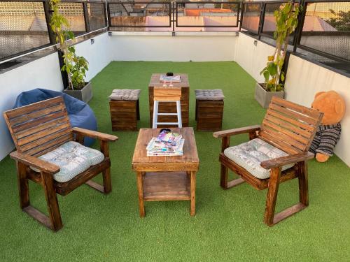 a balcony with two chairs and a table and a table and two chairs at Backpack Hostel in Chiang Rai