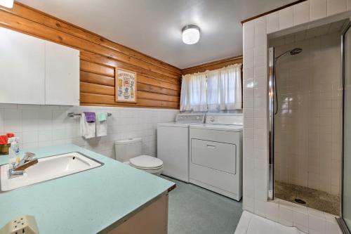 a bathroom with a sink and a toilet and a shower at Waterfront Manson Cabin on Lake Chelan with Deck! in Manson