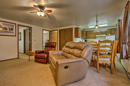 a living room with a couch and a table at Cozy Anglers Apt - Steps to Trout Fishing River! in Columbus