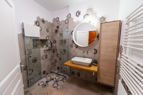ein Bad mit einem Waschbecken und einem Spiegel in der Unterkunft Poarta Schei 18 in Braşov