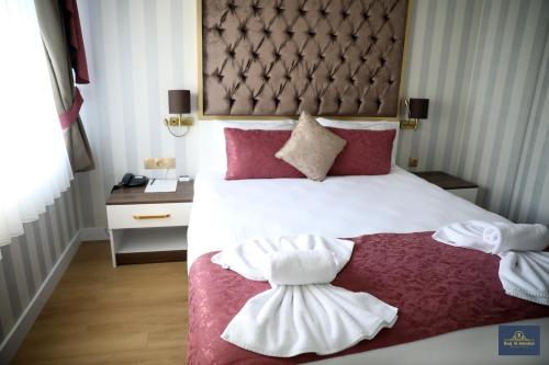 a hotel room with a bed with towels on it at Burj Al Istanbul in Istanbul