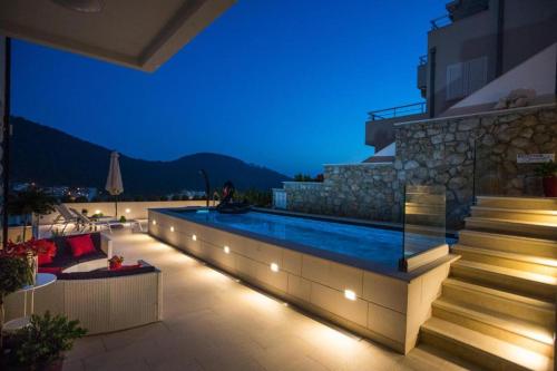 a house with a swimming pool at night at Villa Boro 3 in Dubrovnik