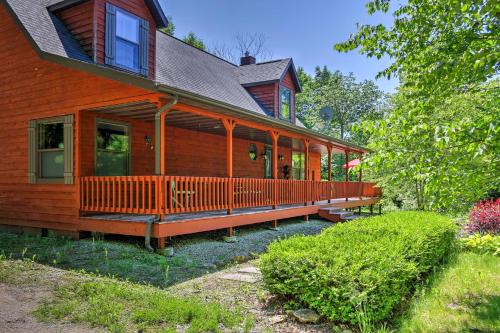 a large wooden house with a large porch at Roomy House on 2 Acres - 2 Mi to Egg Harbor Beach! in Egg Harbor