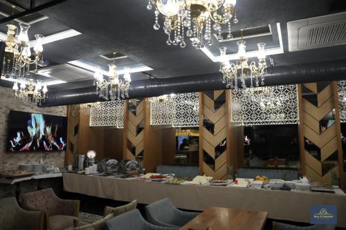 a dining room with chandeliers and a table at Burj Al Istanbul in Istanbul