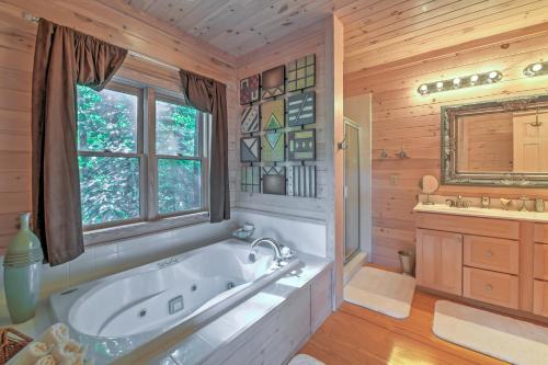 a large bathroom with a tub and a sink at Dream Catcher Luxe Cabin with Large Deck and Mtn View in Sapphire