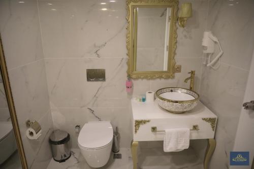 a bathroom with a sink and a toilet and a mirror at Burj Al Istanbul in Istanbul