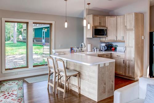 a kitchen with a large island in the middle of a room at Fish on Rice Lake Waterfront Brainerd Cabin in Brainerd