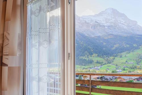 a window with a view of a mountain at Hotel Bel-Air Eden in Grindelwald