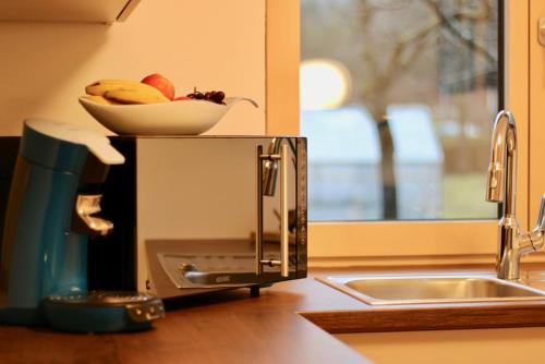 a bowl of fruit sitting on top of a microwave at Ferienhaus Raich in Vandans