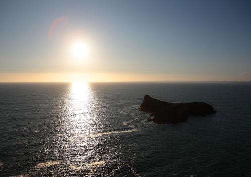 an image of the sun setting over the ocean at Mullion Cove Hotel & Spa in Mullion