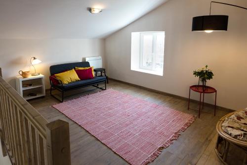 a living room with a couch and a rug at Appartement La Haute Preze & Golffrance in Rouzède