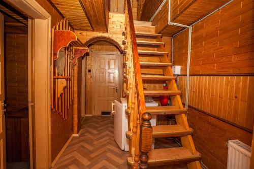 a wooden staircase in a room with a door at Smerekova Hata in Yablunytsya