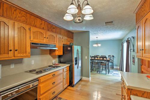 a kitchen with wooden cabinets and a stove top oven at Spacious Georgia Getaway with Dock on Lake Lanier! in Gainesville