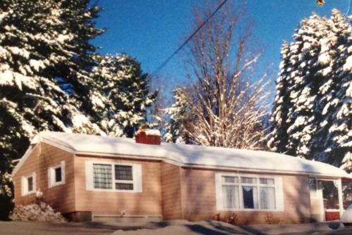 a house with snow on top of it at Mayfield Home with Private Dock on Lake Sacandaga! in Broadalbin