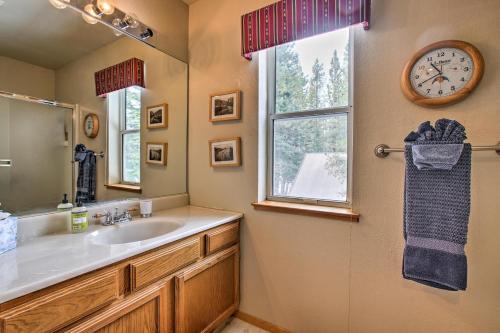 a bathroom with a sink and a clock on the wall at Cabin Less Than 2 Mi to Tahoe Donner Downhill Ski Resort in Truckee