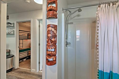 a wooden mask on the wall of a bathroom at Emerald Hideaway Renovated Condo in Navarre Beach in Navarre