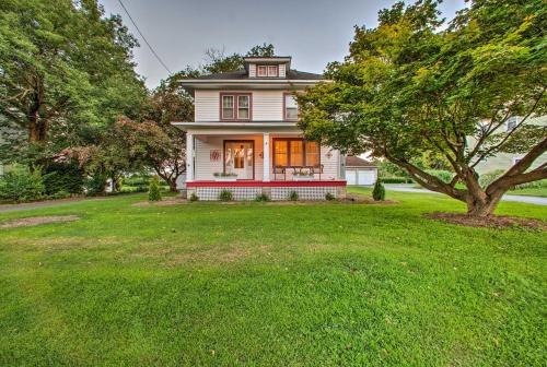 a white house with a tree in a yard at Whimsical Lancaster Home - 4 Mi to Sight and Sound in Lancaster