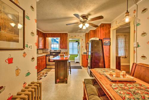 a kitchen with a dining table and a refrigerator at Whimsical Lancaster Home - 4 Mi to Sight and Sound in Lancaster