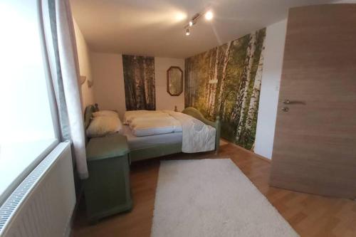 a bedroom with a bed in a room with a window at AnNo - Die Wohlfühl - Idylle in Grünbach_Kirchdorf in Kirchdorf im Wald