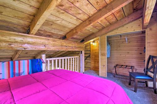 a bedroom with a large pink bed in a cabin at Rustic Idaho Cabin Less Than 10 Mi to Payette Lake! in New Meadows