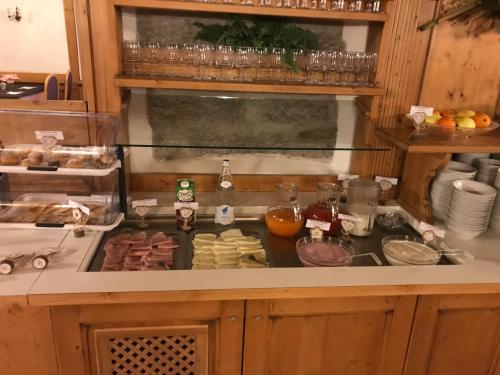 a kitchen with a stove with food on it at Alpen Hotel Vidi in Madonna di Campiglio