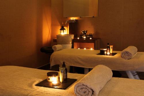 a room with two beds with towels and candles at Sikyon Coast Hotel And Resort in Xylokastron