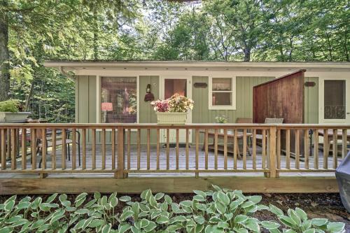 a small green house with a wooden deck at Cozy Cottage Duplex Walk to Peninsula State Park! in Ephraim
