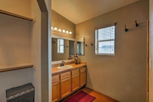 a bathroom with a sink and a mirror at Lake Havasu Getaway with Patio - Hike, Swim, and Golf! in Lake Havasu City