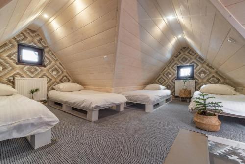 a room with three beds in a attic at Rezydencja Silverton - Piłkarzyki, Ping Pong w obiekcie in Białka Tatrzańska