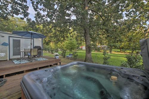 a jacuzzi tub sitting on a deck next to a caravan at Hot Tub and Deck Tranquil Home Near Grand Lake in Grove