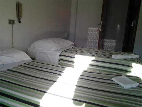 Postel nebo postele na pokoji v ubytování Hotel Guesthouse MASSENA